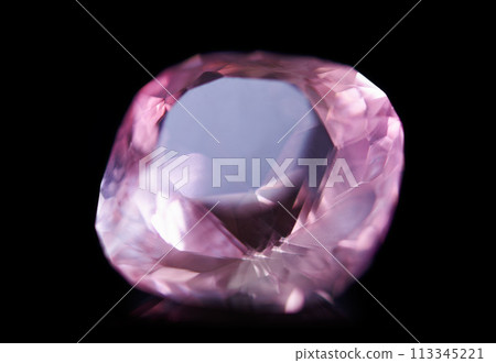 Pink diamond, jewel and stone by black background for natural resource, sparkle and luxury. Rocks, mineral and crystal in closeup for gem with shine, glow and brilliant cut with reflection in studio 113345221