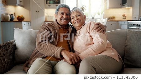 Senior couple, face and hug on couch, smile and bonding with love, support and relax in retirement in home. Elderly woman, old man and portrait with embrace, together and sitting on living room sofa 113345300
