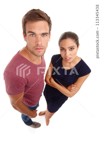 Portrait, top view and annoyed couple in studio with aggressive, attitude or body language on white background. Frustrated, face and people moody with fake news, announcement or marriage counselling 113345438