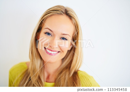 Portrait, smile and woman in a house with confidence, positive attitude and feel good mood on white wall background. Face, happy and female person at home with optimism, relax and chilling on weekend 113345458