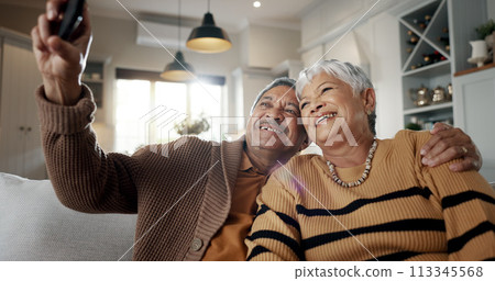 Senior couple, selfie and smile on sofa, hug and bonding with love, support and relax in retirement in home. Elderly woman, old man and happy with profile profile, web blog and social media on couch 113345568
