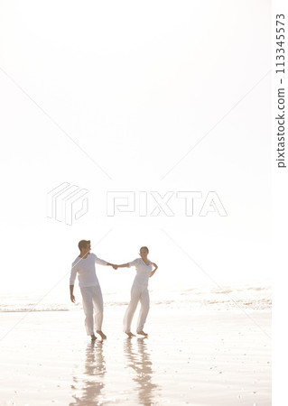 Couple, ocean and holding hands for walk on beach, travel and commitment with trust and bonding outdoor. Love, care and support in relationship, honeymoon or anniversary with fun or playful in nature Couple, ocean and holding hands for walk on beach, travel and commitment with trust and bonding outdoor. Love, care and support in relationship, honeymoon or anniversary with fun or playful in nature 113345573