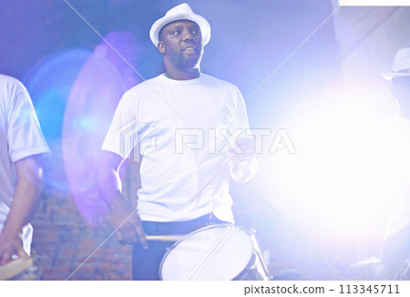Band, carnival and drummer or performance, show and musician in group. Concert, music or fun celebration for musical artist, smile and drum for male Brazilian talent or acoustic with lens flare 113345711