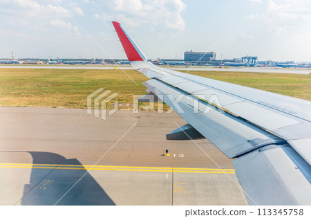 View from the airplane window during takeoff at Sheremetyevo airport at summer View from the airplane window during takeoff at Sheremetyevo airport at summer 113345758