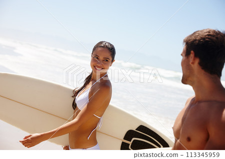 Couple, beach and surfboard for surfing or smile with swimwear, adventure and fitness with blue sky. Man, woman and surfer by ocean in morning with holiday, vacation and freedom with bonding and care Couple, beach and surfboard for surfing or smile with swimwear, adventure and fitness with blue sky. Man, woman and surfer by ocean in morning with holiday, vacation and freedom with bonding and care 113345959