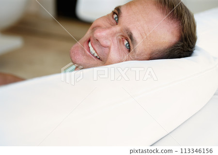 Portrait, man or sofa to relax at weekend in peace, health or wellness as easy, self care or holiday. Tired, happy or mature male person on couch as lazy, break or comfort as rest and relaxation 113346156