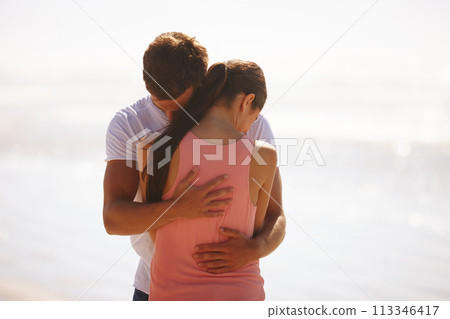 Couple, hug and comfort at beach with love, woman and man with affection, care and time together outdoor. Safety, security and trust for comfort or support with kindness in relationship and embrace 113346417