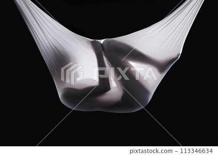 Person, fabric and wrapped naked in studio, abstract and creative art on black background. Woman, girl and material for ethereal or phantom ghost, bare and nude in sheet for fetus illusion in cloth 113346634