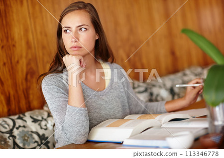 Woman, thinking and home with textbook to study for university exams or test and reading notes. female person, college and student in living room or lounge for distance learning and revision. 113346778