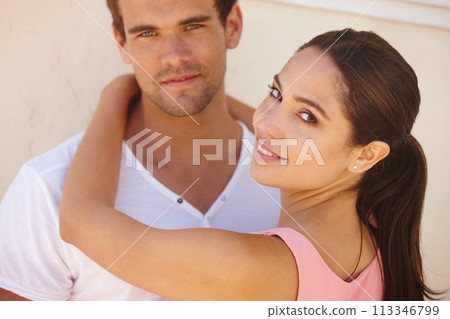 Couple, portrait and smile with hug by wall for healthy relationship, anniversary date and summer holiday. Support, man and woman with embrace, happiness and affection for trust, comfort and care 113346799