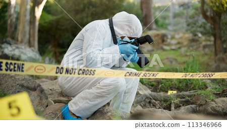 Forensic, photographer and police tape at crime scene for investigation in forest with evidence and safety hazmat..Csi quarantine, expert investigator and pictures for observation and case research 113346966