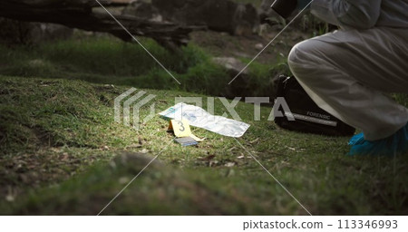 Csi, photographer and evidence at crime scene for investigation in forest with wallet or safety hazmat..Forensic photography, expert investigator and pictures for observation or case research outdoor 113346993
