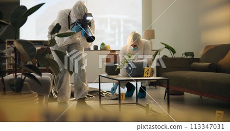 Crime scene, photography and people in house for evidence, investigation and inspection. Law enforcement, forensic analysis and police team take pictures in apartment of victim, murder and search 113347031