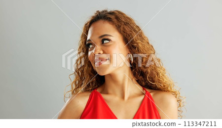 Happy woman person, wink and laughing in studio, excited and flirt on grey background. Cheerful, joyful and smile on female model face, friendly and natural with curly hair of fun African Lady Happy woman person, wink and laughing in studio, excited and flirt on grey background. Cheerful, joyful and smile on female model face, friendly and natural with curly hair of fun African Lady 113347211