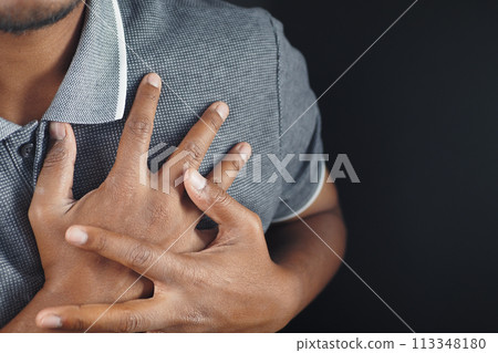 young man suffering pain in heart and holding chest with hand  113348180