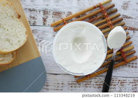 Slice of bread and cream cheese on white background. Slice of bread and cream cheese on white background. 113348219