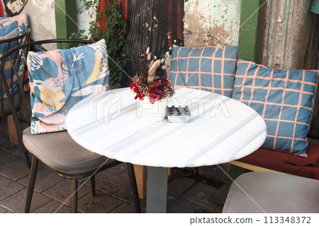 Furniture table with a vase of flowers, perfect for decorating a house Furniture table with a vase of flowers, perfect for decorating a house 113348372
