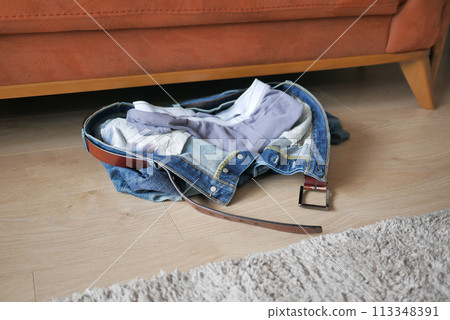 Jeans thrown off on the floor Jeans thrown off on the floor 113348391