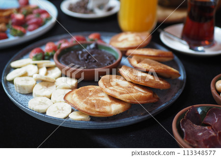 pan cake served with banana and strawberry pan cake served with banana and strawberry 113348577
