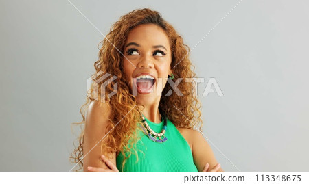 Woman, fashion and happy with hair in studio on white background, wink and necklace with trendy outfit. Closeup, female person and excited with colorful top for style, clothes and accessories 113348675