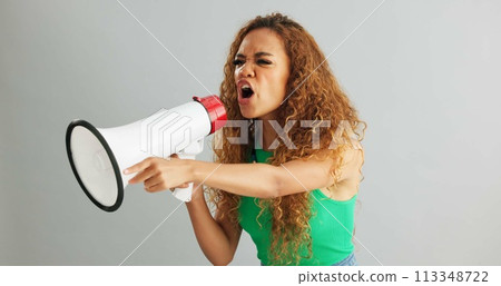 Angry woman, shouting and protest with megaphone for power, rights or equality on a gray studio background. Frustrated female person or activist screaming with fist and bullhorn for announcement Angry woman, shouting and protest with megaphone for power, rights or equality on a gray studio background. Frustrated female person or activist screaming with fist and bullhorn for announcement 113348722
