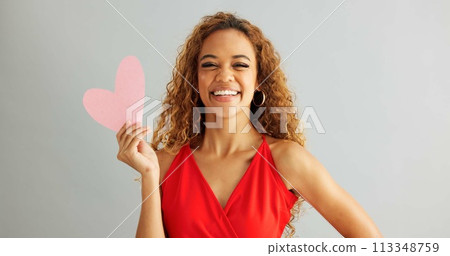 Woman, love and kiss face with paper heart for opinion, romance or thinking with ideas on grey background. Face, emoji and female person with happiness for kindness, vote or support on valentines day Woman, love and kiss face with paper heart for opinion, romance or thinking with ideas on grey background. Face, emoji and female person with happiness for kindness, vote or support on valentines day 113348759