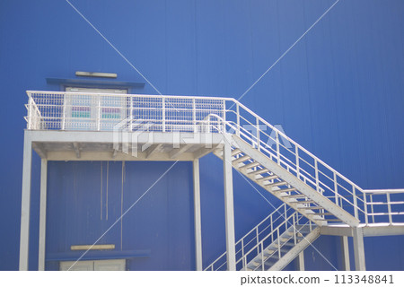 A sky blue building with white stairs leading up to it A sky blue building with white stairs leading up to it 113348841