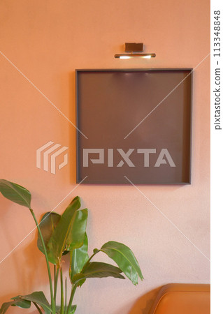Black frame mockup in a living room hanging on a wall  113348848