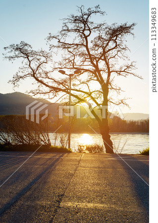 sunset over lake with mountains sunset over lake with mountains 113349683