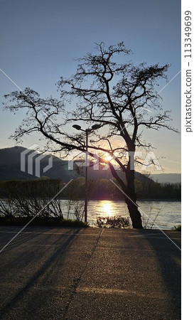 sunset over lake with mountains sunset over lake with mountains 113349699