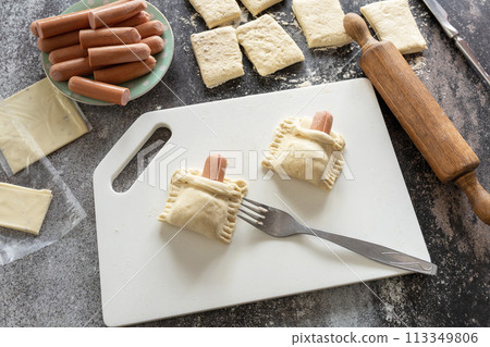 Cooking Easter rabbit-shaped buns puff pastry from sausage and cheese, step by step, step 4. 113349806