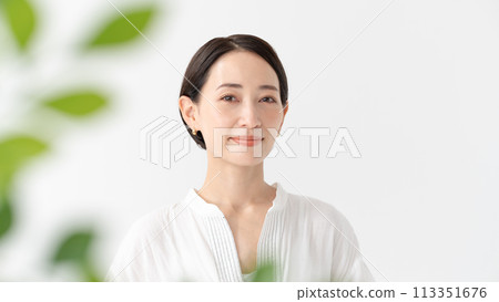 Middle-aged woman portrait green 113351676