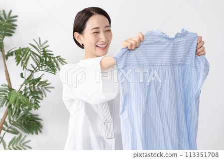Woman holding clothes washing 113351708