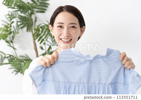 Woman holding clothes washing 113351711