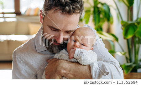 Father holding his newborn baby. Unconditional paternal love, Father's Day concept. 113352684