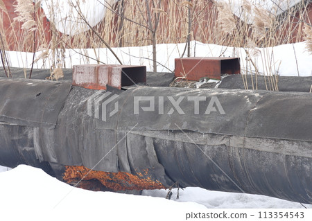 The main provides the city with hot water. Selective focus. The pipes of the central heating system The main provides the city with hot water. Selective focus. The pipes of the central heating system 113354543