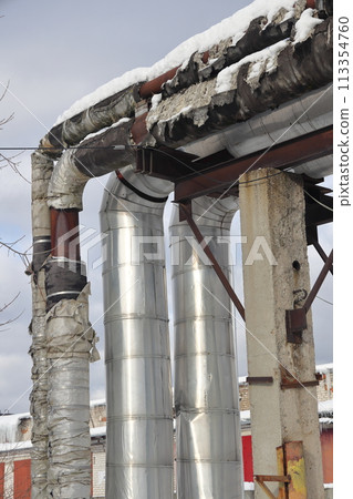 The main provides the city with hot water. Selective focus. The pipes of the central heating system The main provides the city with hot water. Selective focus. The pipes of the central heating system 113354760