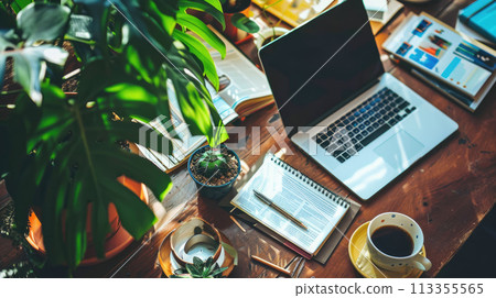 Desktop with a laptop, magazines, office stationery, plant and cup of coffee. Close up of office desk 113355565