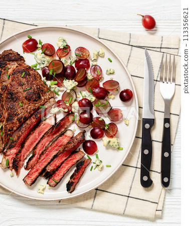 fried beef steak with salad of grape, cheese 113356621