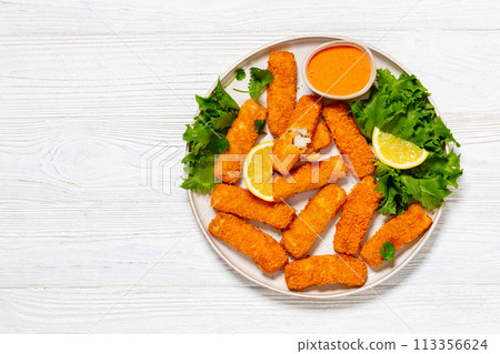 crispy fried breaded fish sticks on a plate 113356624