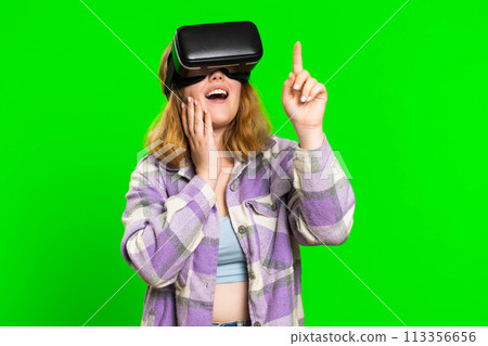 Excited woman in VR headset helmet watching virtual reality 3D video, playing simulation online game Excited woman in VR headset helmet watching virtual reality 3D video, playing simulation online game 113356656