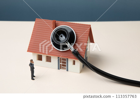 Miniature businessman and house with stethoscope 113357763