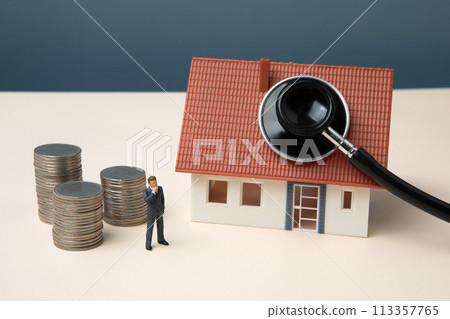 Miniature businessman with stethoscope, house and coins Miniature businessman with stethoscope, house and coins 113357765