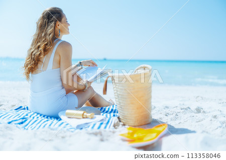 relaxed modern woman on seacoast with straw bag relaxed modern woman on seacoast with straw bag 113358046