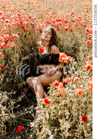 Woman poppies field. portrait happy woman with long hair in a poppy field and enjoying the beauty of nature in a warm summer day. 113358056