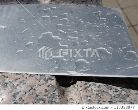 drops of rain on steel plate 113358077