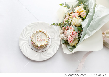 Festive bento cake and bouquet on a light background 113358174