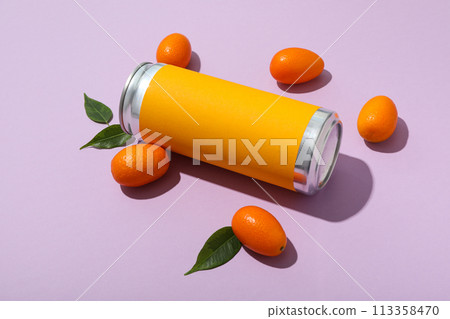 Tin can and kumquats on purple background, close up 113358470