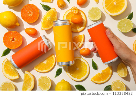 Tin cans, citrus fruits and hand on white background, top view 113358482
