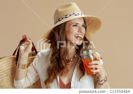 smiling elegant woman in blouse and shorts on beige smiling elegant woman in blouse and shorts on beige 113358484